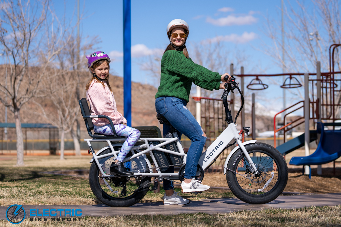 Woman riding the Lectric XPedition with a child